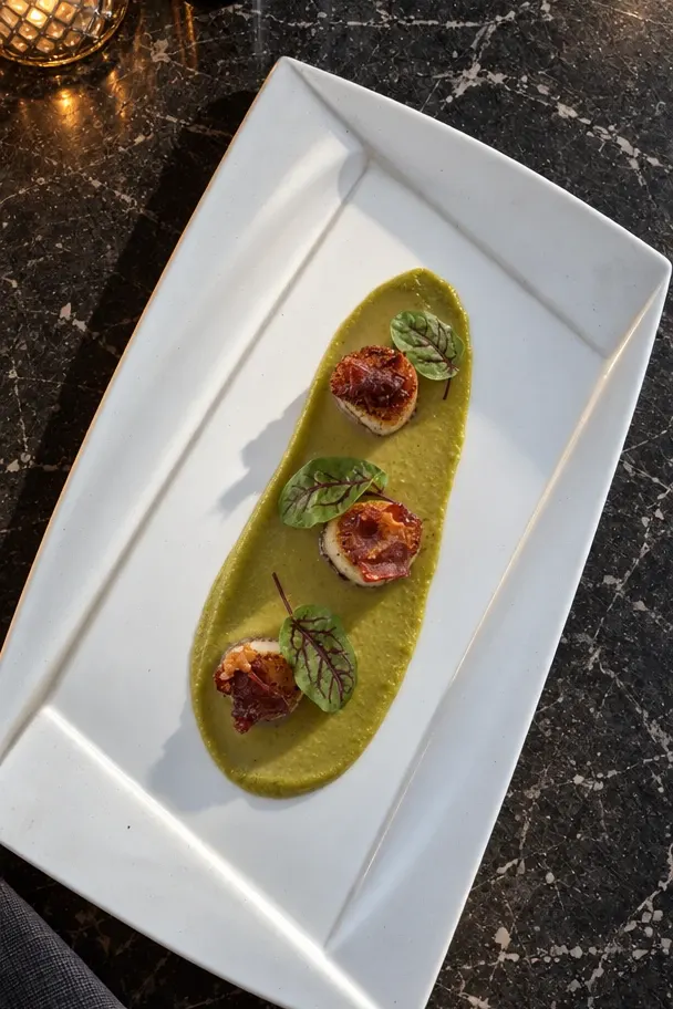 Studio shots of the scallops at the bar: top-down, up close, side-on, diner’s view, served.